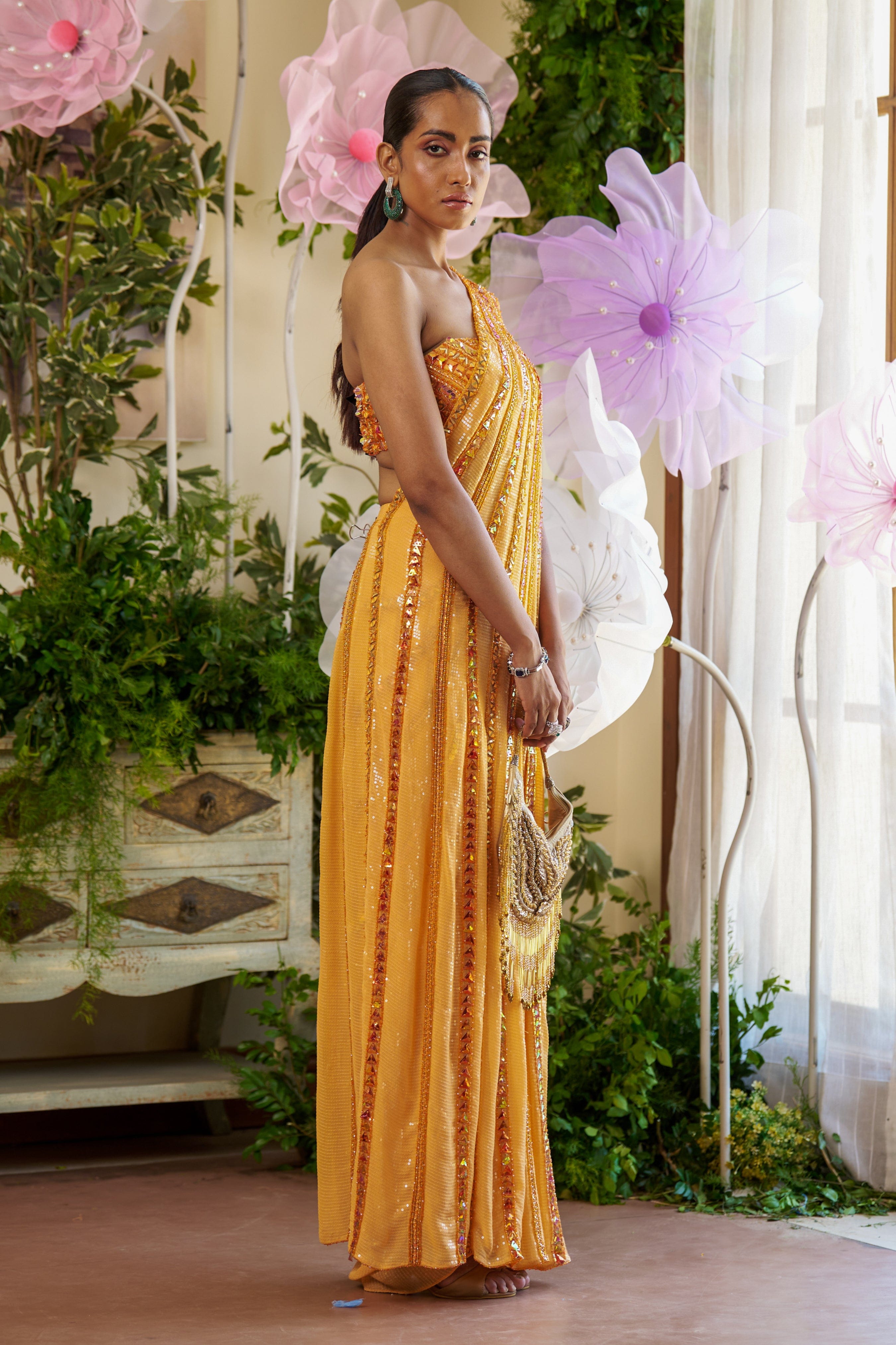 Side profile of the Zia Saree showcasing its asymmetric drape and fitted blouse design.