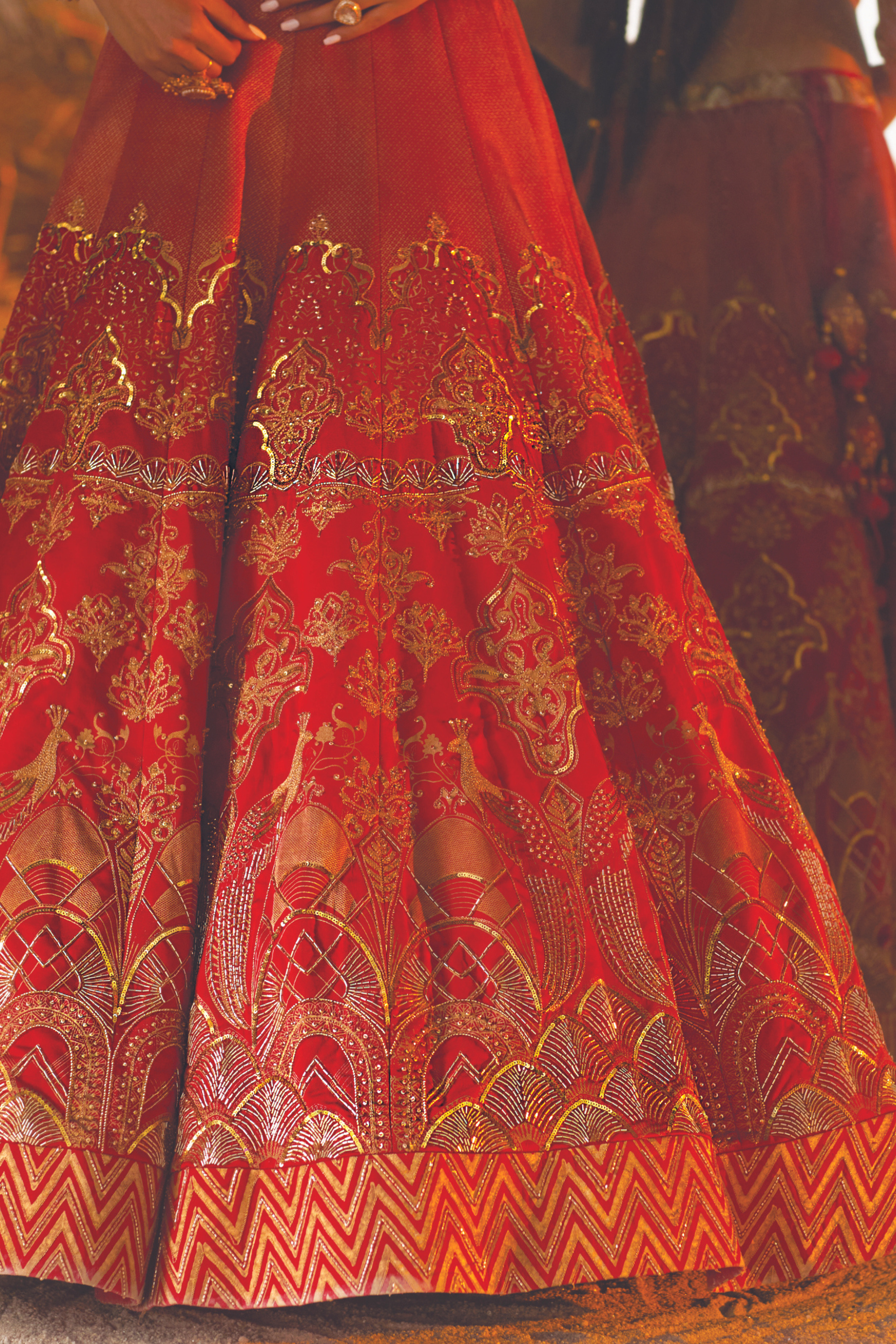 Red bridal lehenga adorned with intricate embroidery, sequins, and handcrafted detailing.