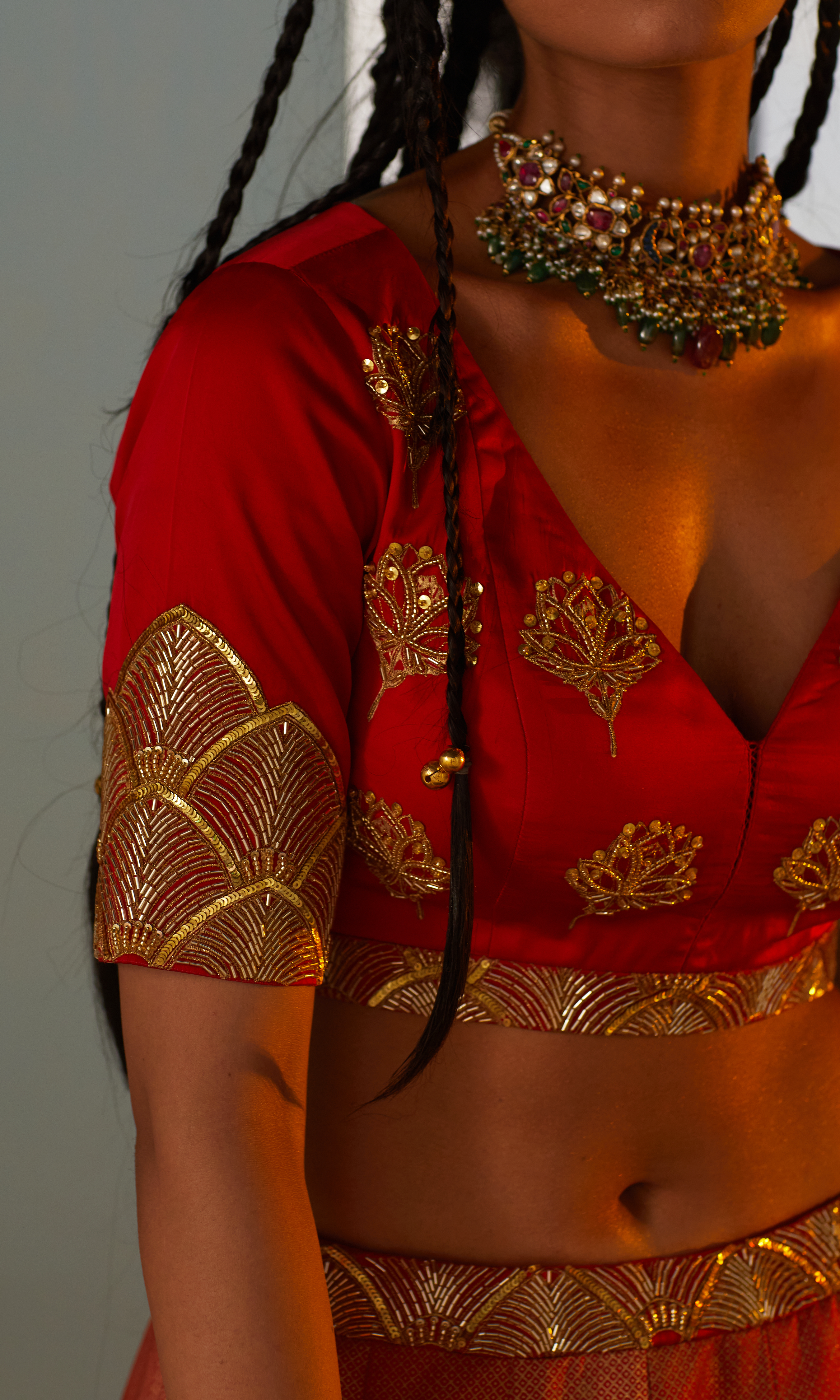 Hand-embroidered blouse with floral motifs, gold printing, and a structured fit.