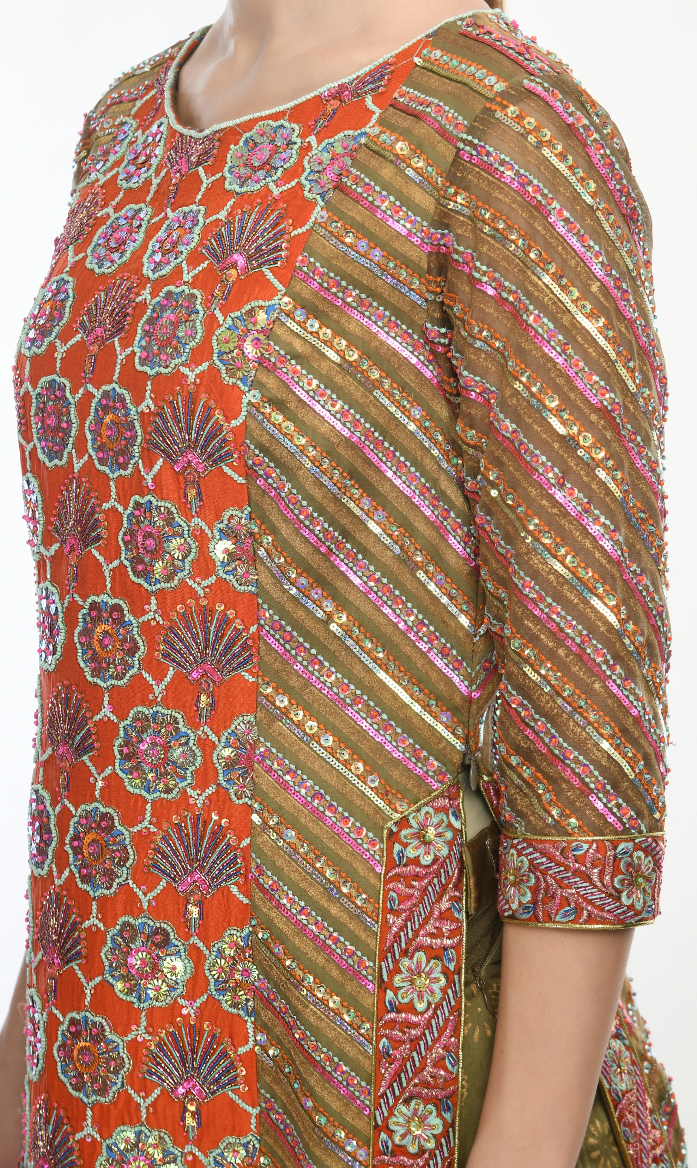 Close-up of heavily embellished sheer sleeves with intricate embroidery and beadwork.