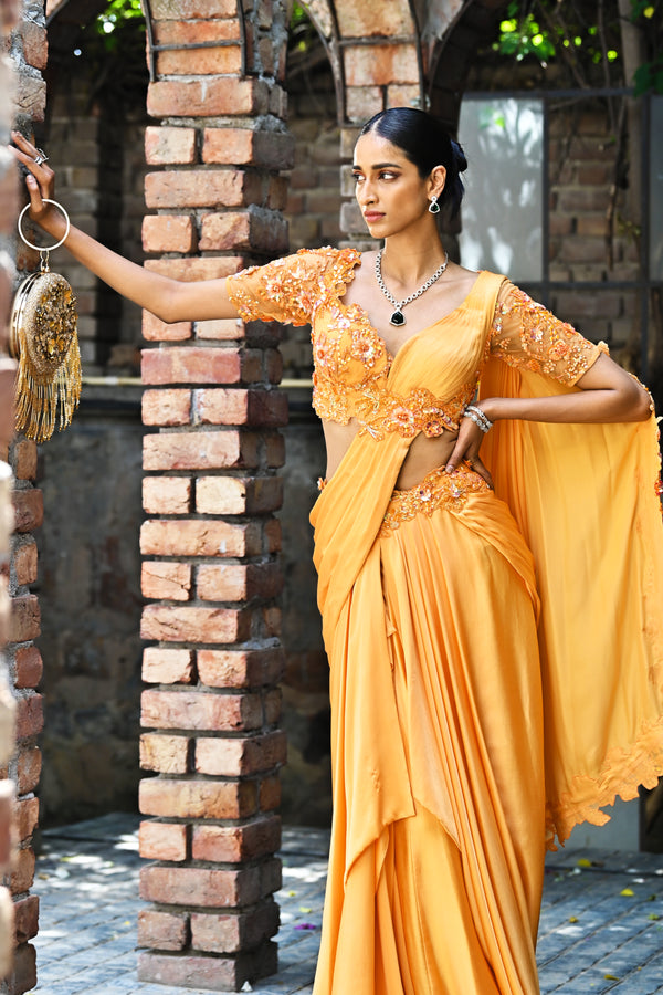 Pre-draped Shahpurjat Saree with flowing fabric and delicate floral embellishments.
