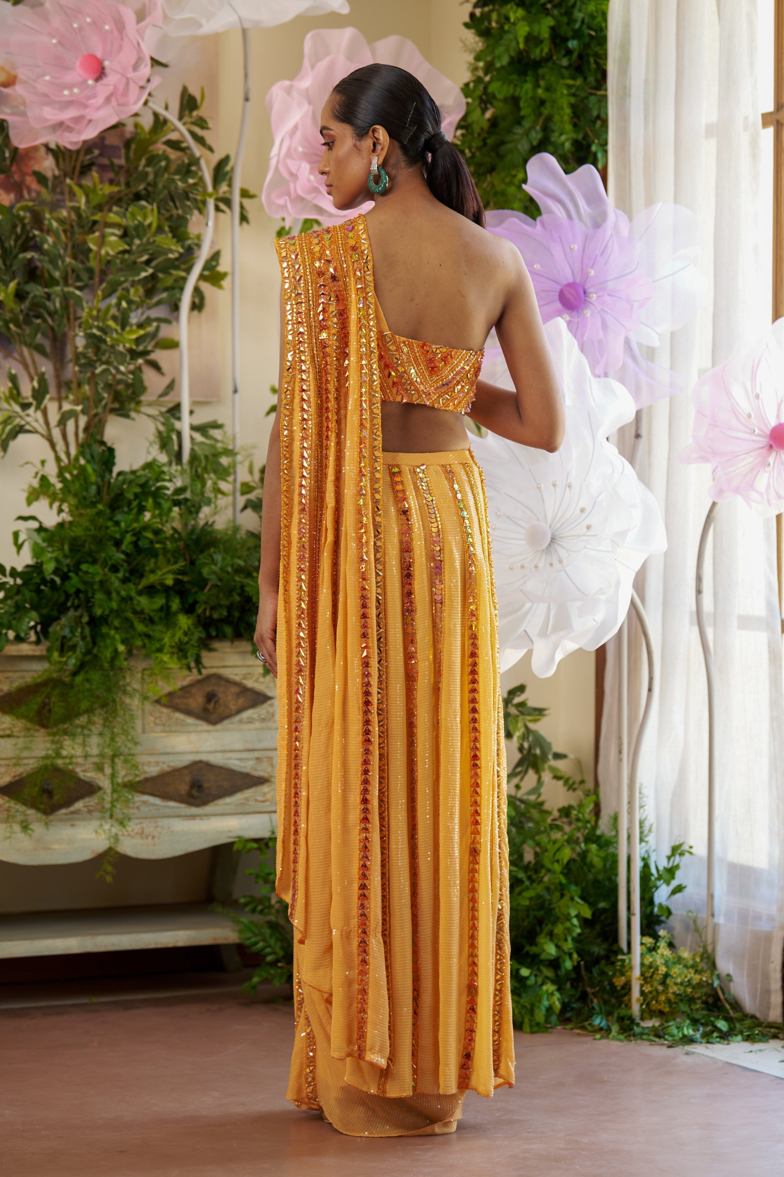 Bridal Saree featuring an asymmetrical drape and a sleek one-shoulder blouse with bead detailing.