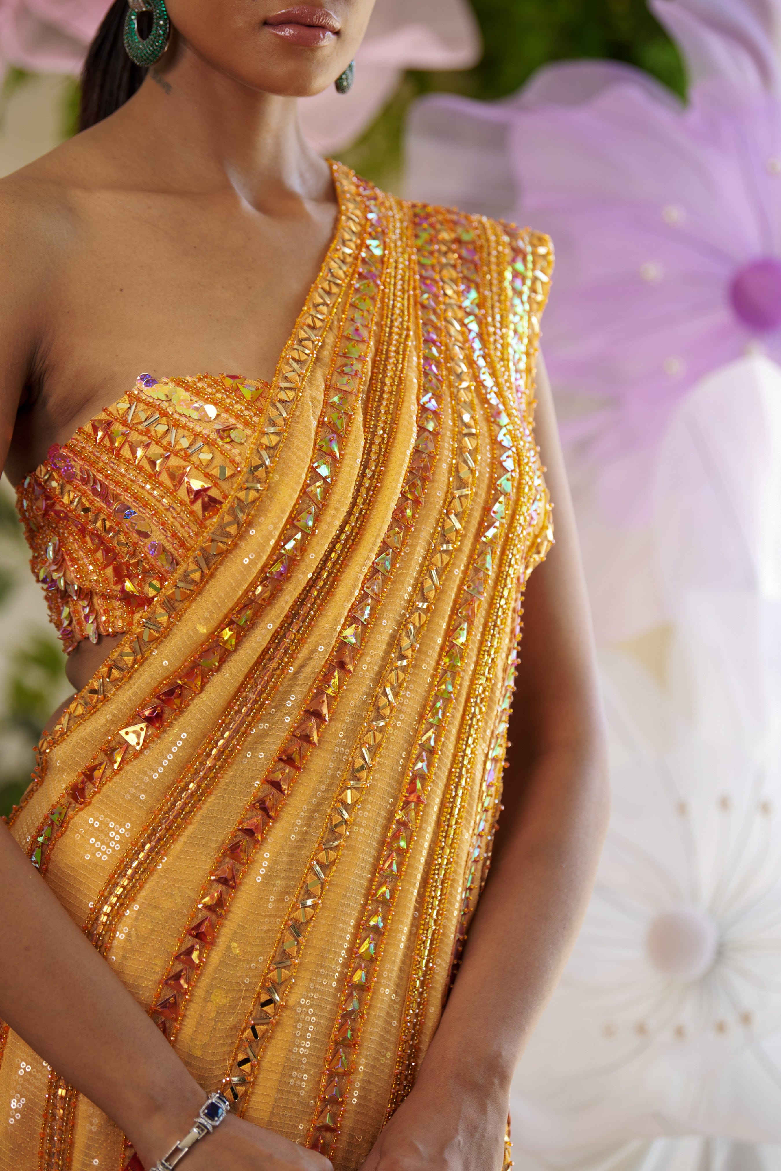 Crystal and bead-adorned one-shoulder blouse crafted from butterfly net for a Shahpurjat Saree look.