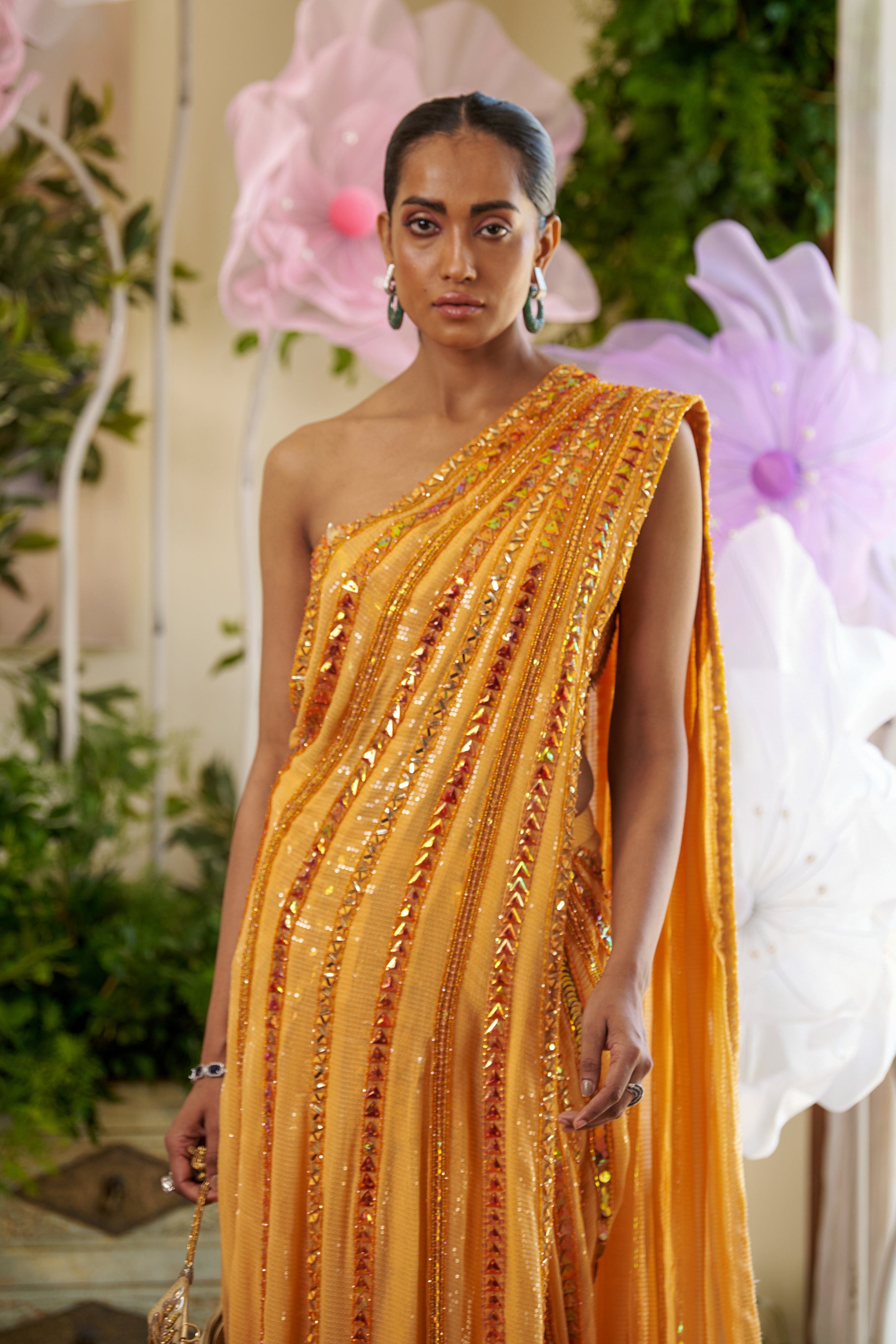 Lightweight sequined fabric draping from the right side for a modern bridal saree.