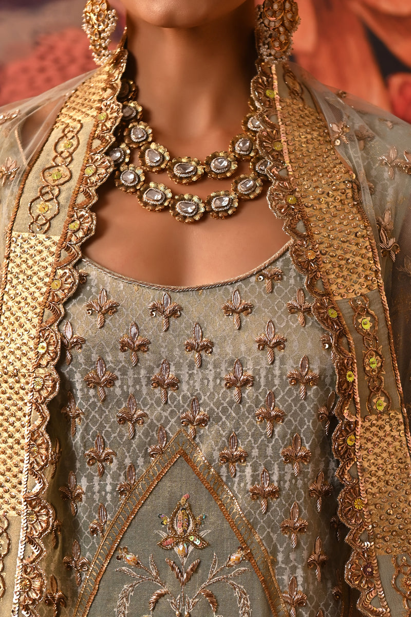Close-up of the pista green kurta with intricate dabka embroidery, golden highlights, and embroidered cuffs by Moledro.