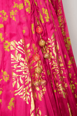 Pink lehenga with artistic floral patterns and tone-on-tone design.