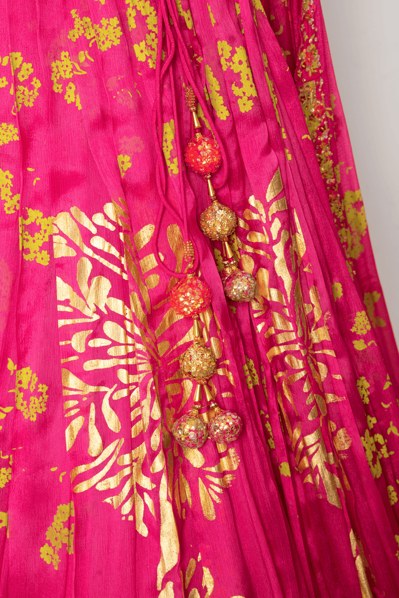Pink lehenga with artistic floral patterns and tone-on-tone design.