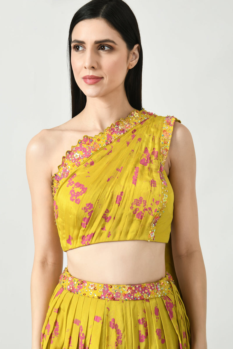 One-shoulder blouse with intricate floral designs and an attached flowing dupatta.