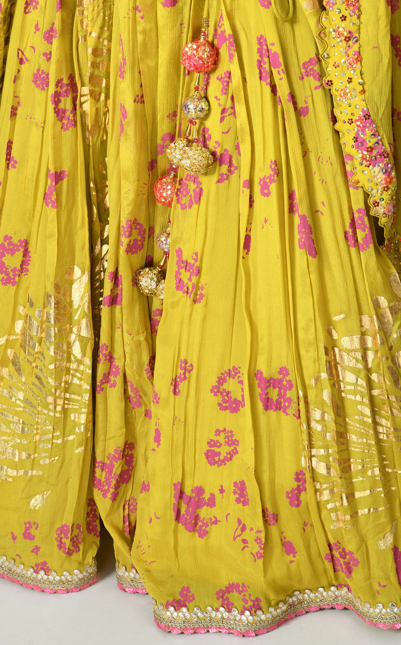 Flowing green lehenga with tone-on-tone patterns and floral accents.