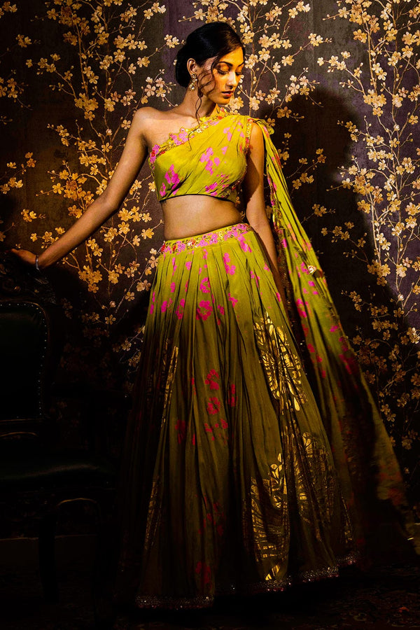 Humaira Lehenga Set with a green one-shoulder blouse, floral motifs, and attached scallop-detail dupatta.