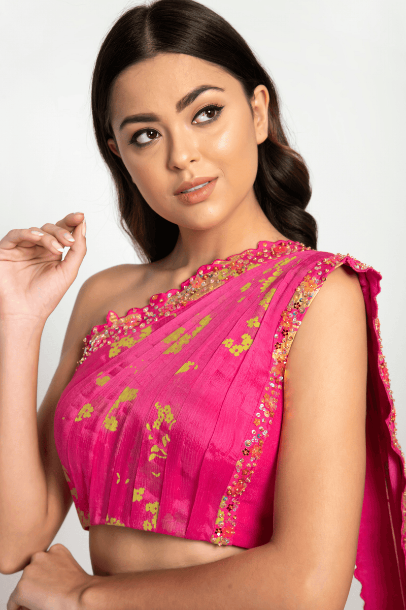 Detailed craftsmanship on the one-shoulder blouse with attached dupatta.