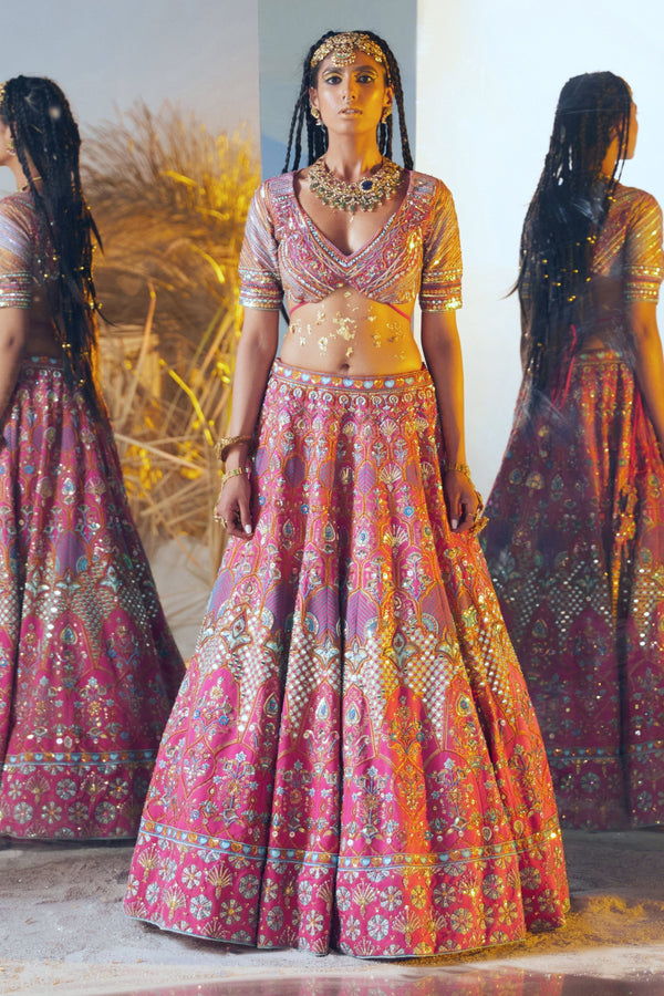 Luxurious modal satin lehenga paired with a butterfly net dupatta for a bridal look.