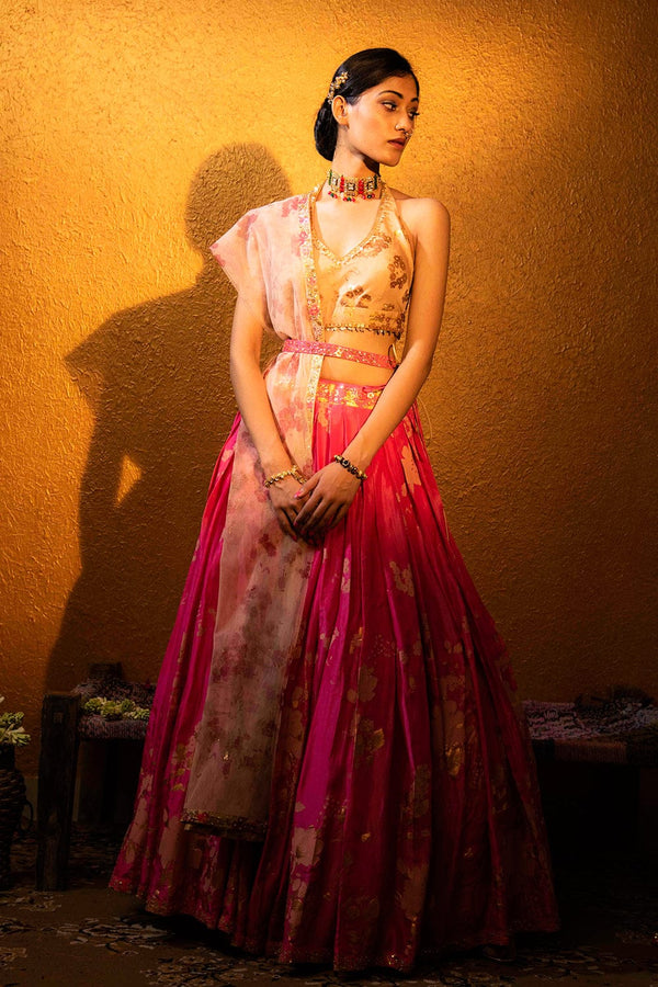 Mahira Lehenga Set in fuchsia featuring a halter neck blouse, gold foil lehenga, and printed dupatta.