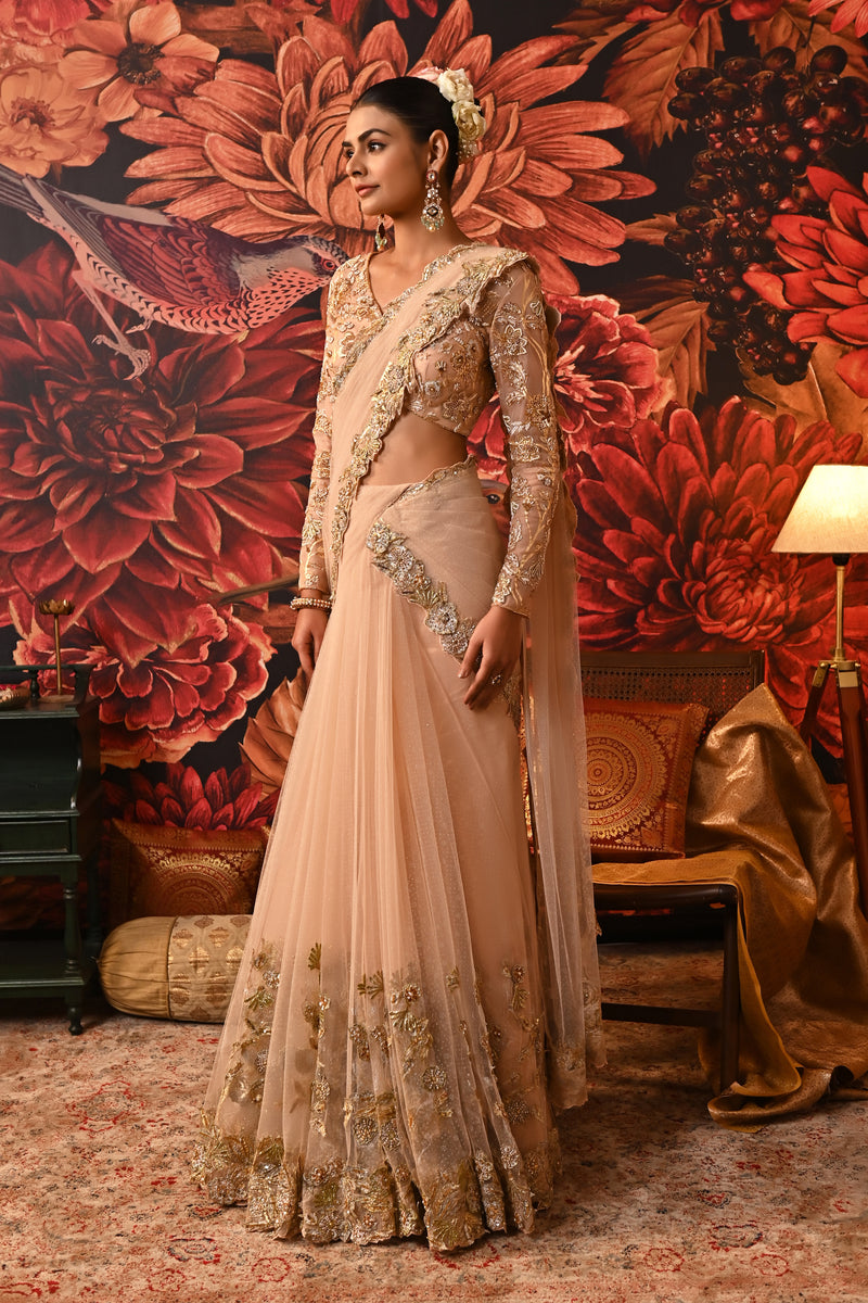 Pre-draped wedding saree with embroidered patchwork on the pallu and cutwork hem.
