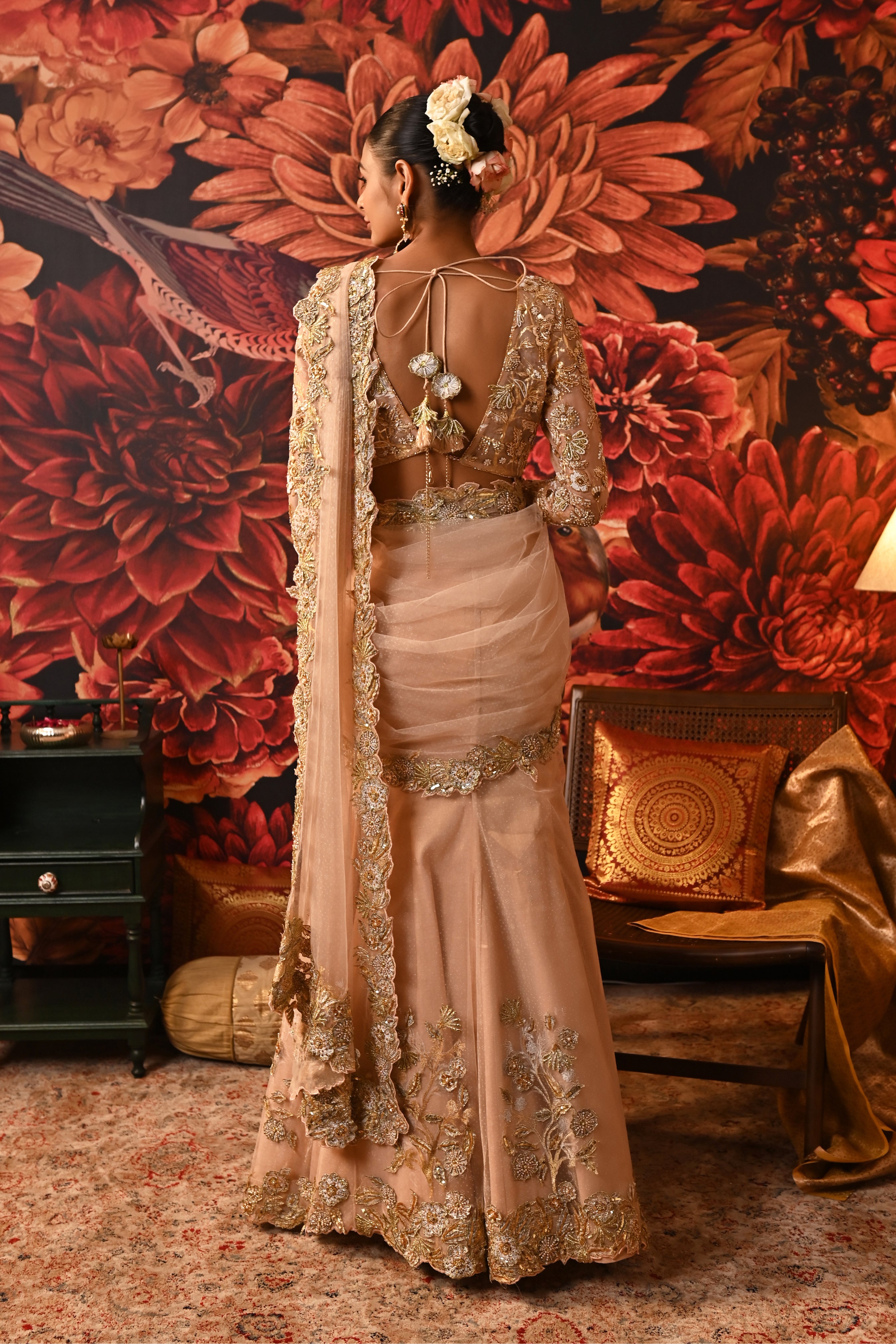 Wedding saree featuring a deep V-neck full-sleeve blouse with gold-foil details and chain closure.