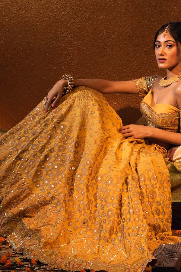 Flowing yellow lehenga skirt with gold-copper foil accents, ideal for festive occasions.